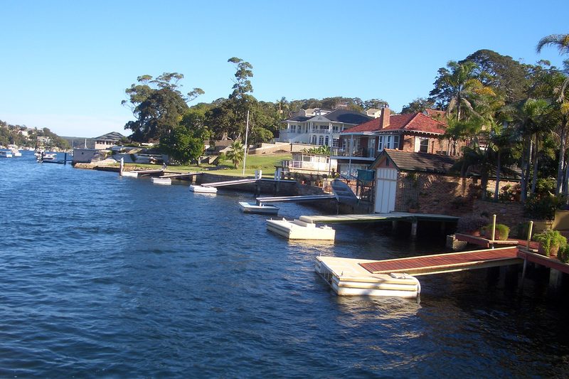 Waterfront homes and private jetties along the shore at Yowie Bay