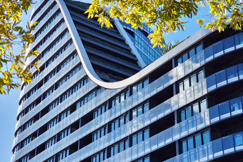 The curved façade of an apartment building at Green Square, Zetland